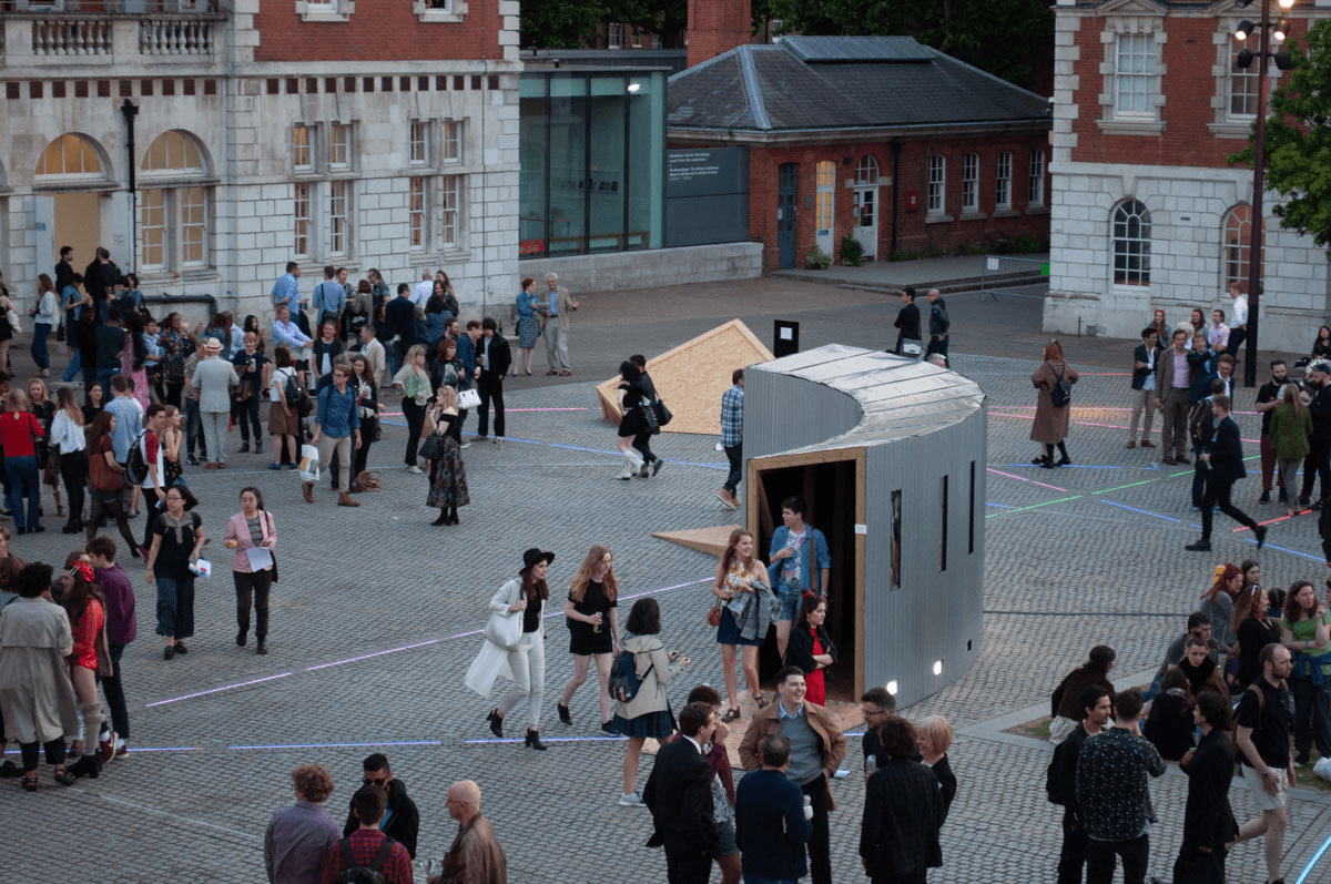 Anta Germane public artwork entrance during private view from above in an areal view. Interactive Tunnel is constructed from steel sheets, timber, one way persepx mirrors, PIR sensors and lights, situated in London Rootstein Hopkins Parade Ground.