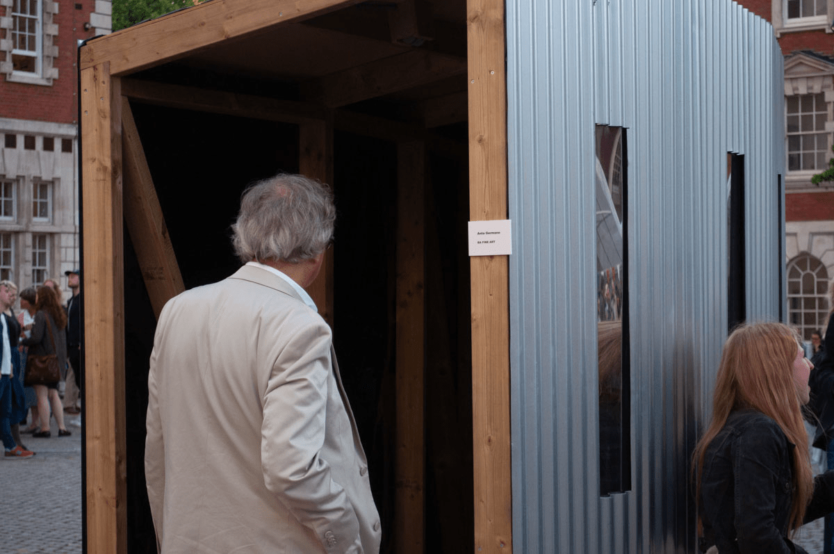 Anta Germane public artwork entrance during private view. Interactive Tunnel is constructed from steel sheets, timber, one way persepx mirrors, PIR sensors and lights, situated in London Rootstein Hopkins Parade Ground.