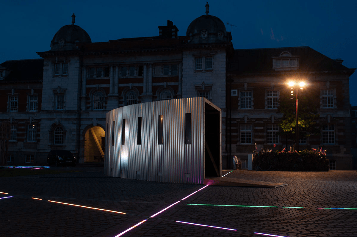 Anta Germane public artwork Interactive Tunnel constructed from steel sheets, timber, one way persepx mirrors, PIR sensors and lights, situated in London Rootstein Hopkins Parade Ground.